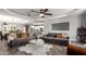 Spacious living room featuring modern furniture, ceiling fan, and views to kitchen at 8113 S 42Nd Dr, Laveen, AZ 85339