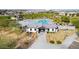 Scenic aerial shot of the community clubhouse and pool area, surrounded by palm trees and desert landscaping at 8318 W Palo Verde Dr, Glendale, AZ 85305