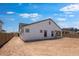 Large backyard featuring a white home with a covered patio and room for landscaping at 8318 W Palo Verde Dr, Glendale, AZ 85305