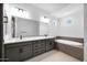 Bathroom with double sink vanity, soaking tub, and tile flooring at 8318 W Palo Verde Dr, Glendale, AZ 85305
