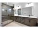 Modern bathroom with dual vanity sinks and frameless glass shower at 8318 W Palo Verde Dr, Glendale, AZ 85305