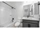 Bright bathroom with a shower-tub, toilet, sink, vanity, and stylish black hardware at 8318 W Palo Verde Dr, Glendale, AZ 85305
