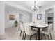 Elegant dining room with a modern chandelier, neutral-toned walls, and stylish table setting for entertaining at 8318 W Palo Verde Dr, Glendale, AZ 85305