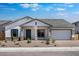 Charming single-story home featuring a stone-accented facade, desert landscaping, and a two-car garage at 8318 W Palo Verde Dr, Glendale, AZ 85305