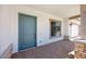 Inviting front porch with brick pavers and a blue front door, offering a welcoming entrance to the home at 8318 W Palo Verde Dr, Glendale, AZ 85305