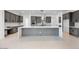 Spacious kitchen with an oversized island, sleek gray cabinets, and modern appliances for a chef-inspired space at 8318 W Palo Verde Dr, Glendale, AZ 85305