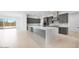Modern kitchen with gray cabinets, a large island, stainless steel appliances, and tile flooring throughout at 8318 W Palo Verde Dr, Glendale, AZ 85305