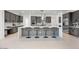 Elegant kitchen featuring a large island with seating, gray cabinetry, and stainless steel appliances at 8318 W Palo Verde Dr, Glendale, AZ 85305