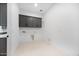 Neat laundry room with gray cabinetry and tile floors, ready for your appliances at 8318 W Palo Verde Dr, Glendale, AZ 85305