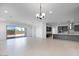 Spacious open floor plan with sliding glass doors, a modern kitchen, and tile flooring, ideal for modern living at 8318 W Palo Verde Dr, Glendale, AZ 85305