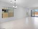 Bright, expansive living space boasts neutral tile flooring, recessed lighting, and access to the outdoors at 8318 W Palo Verde Dr, Glendale, AZ 85305
