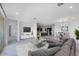 Bright and open living room with a comfortable sofa, modern decor, and seamless flow into the dining area at 8318 W Palo Verde Dr, Glendale, AZ 85305