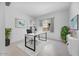 Bright office space features a modern desk, white shelving, and large window, creating an inviting workspace at 8318 W Palo Verde Dr, Glendale, AZ 85305