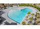 Aerial view of a heart-shaped pool surrounded by palm trees and lounge chairs, perfect for community relaxation at 8318 W Palo Verde Dr, Glendale, AZ 85305