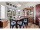 Bright dining room featuring a sliding glass door and a hutch filled with collectibles and dishware at 839 E Leo Pl, Chandler, AZ 85249