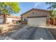 Lovely home exterior with a two-car garage, desert landscaping, and lush trees surrounding the property at 839 E Leo Pl, Chandler, AZ 85249