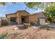 Charming home exterior with a front porch, desert landscaping, and an attached two-car garage at 839 E Leo Pl, Chandler, AZ 85249