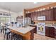 Eat-in kitchen featuring stainless steel appliances, a white countertop island, and tile flooring at 839 E Leo Pl, Chandler, AZ 85249