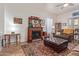 Cozy living room with a decorative fireplace, soft lighting, and a comfortable brown sofa set at 839 E Leo Pl, Chandler, AZ 85249
