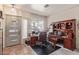This home office is naturally lit with windows and includes a door for privacy and a traditional executive desk at 839 E Leo Pl, Chandler, AZ 85249