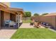 The backyard offers a covered patio, artificial turf, and charming desert landscaping at 9125 E Gelding Dr, Scottsdale, AZ 85260