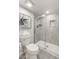 Neutral tiled bathroom showcases a walk-in shower and a toilet with stacked fluffy towels at 9125 E Gelding Dr, Scottsdale, AZ 85260