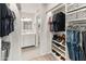 The bathroom features a modern white vanity and connects to a closet with built-in shelving at 9125 E Gelding Dr, Scottsdale, AZ 85260