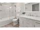 Charming bathroom showcases white fixtures, a modern vanity and a tub-shower combo at 9125 E Gelding Dr, Scottsdale, AZ 85260