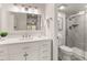 Bright bathroom boasts a modern vanity and a glass-enclosed shower with neutral tile at 9125 E Gelding Dr, Scottsdale, AZ 85260