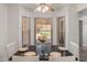 Cozy dining area features a dark wood table and white chairs, complemented by a bay window with natural light at 9125 E Gelding Dr, Scottsdale, AZ 85260
