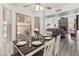 Charming dining area open to the living room boasts wood floors, a ceiling fan, and views of the fireplace at 9125 E Gelding Dr, Scottsdale, AZ 85260