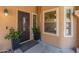 A welcoming front entrance, adorned with potted plants, inviting guests into a cozy, stylish home at 9125 E Gelding Dr, Scottsdale, AZ 85260