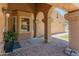 A charming front porch with decorative columns, offering a shaded entrance and inviting curb appeal at 9125 E Gelding Dr, Scottsdale, AZ 85260