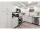 Modern white kitchen featuring stainless steel appliances and ample cabinet space for storage at 9125 E Gelding Dr, Scottsdale, AZ 85260
