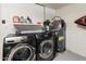 Well-equipped laundry room with washer, dryer, and storage shelves for laundry supplies and essentials at 9125 E Gelding Dr, Scottsdale, AZ 85260