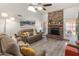 Comfortable living room with stone fireplace, neutral palette, and access to outdoor patio at 9125 E Gelding Dr, Scottsdale, AZ 85260