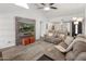 Comfortable living room with a mounted TV, gray couches, and a view of the dining area and front door at 9125 E Gelding Dr, Scottsdale, AZ 85260