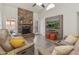 Inviting living room featuring a stone fireplace, plush seating, and modern entertainment setup at 9125 E Gelding Dr, Scottsdale, AZ 85260