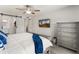 Bright main bedroom with a large TV, barn door to closet, and view of the en suite bathroom at 9125 E Gelding Dr, Scottsdale, AZ 85260