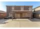 View of the back of the house and covered patio with large concrete pad at 9207 W Kirby Ave, Tolleson, AZ 85353