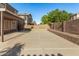 Backyard featuring a concrete pad with brick privacy wall on right at 9207 W Kirby Ave, Tolleson, AZ 85353