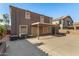 View of the back of the house and covered patio with large concrete pad at 9207 W Kirby Ave, Tolleson, AZ 85353