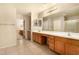 Large bathroom with double sinks, vanity, tile floors, and separate shower and toilet rooms at 9207 W Kirby Ave, Tolleson, AZ 85353