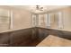 Bedroom with wood floors, ceiling fan, and multiple windows letting in natural light at 9207 W Kirby Ave, Tolleson, AZ 85353