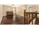 Bedroom featuring hardwood floors and stairwell featuring wooden railing at 9207 W Kirby Ave, Tolleson, AZ 85353