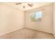 Neutral bedroom features a ceiling fan and a bright window view at 9207 W Kirby Ave, Tolleson, AZ 85353