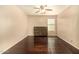 Bedroom featuring hardwood floors, ceiling fan, and matching dresser at 9207 W Kirby Ave, Tolleson, AZ 85353