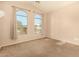 Carpeted bedroom with large windows offering natural light and outdoor views at 9207 W Kirby Ave, Tolleson, AZ 85353