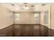 Spacious bedroom features hardwood floors, ceiling fan, and well-lit atmosphere at 9207 W Kirby Ave, Tolleson, AZ 85353