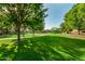 Beautiful community park featuring green grass, mature trees, walking path and a playground for outdoor enjoyment at 9207 W Kirby Ave, Tolleson, AZ 85353